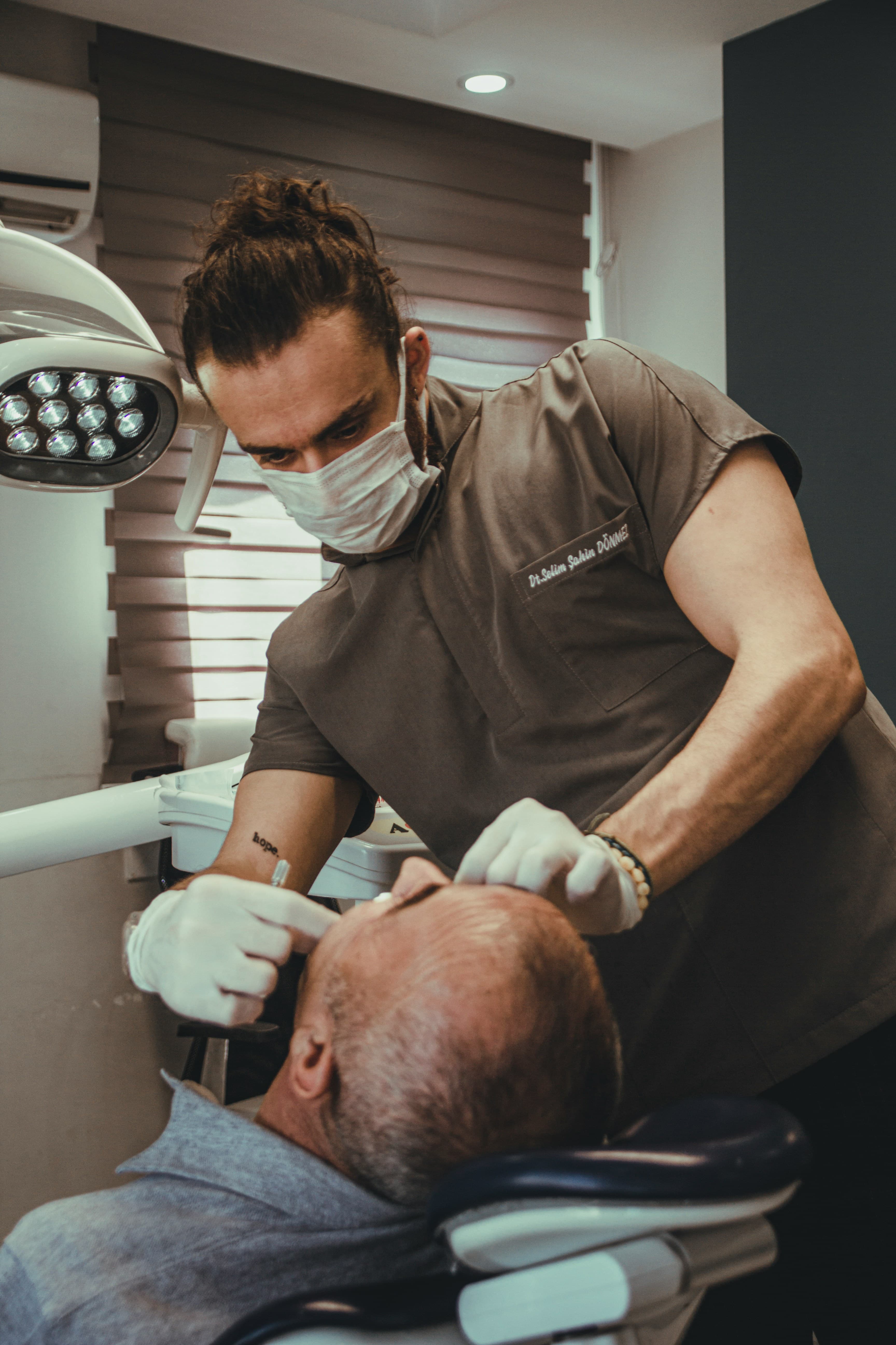 Smiling patient sitting in contemporary dental studio lounge